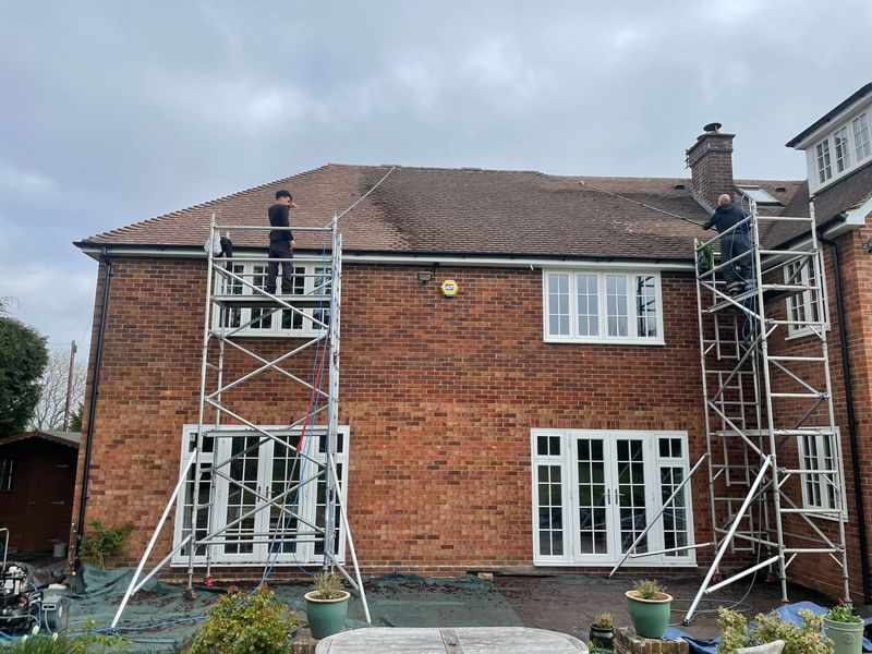 Roof cleaning carried out safely from scaffold towers by The Roof Moss Cleaners in Kingswood